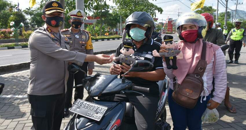 Kapolres Trenggalek saat memberikan hadiah kepada pengendara yang patuh aturan lalin dan prokes.